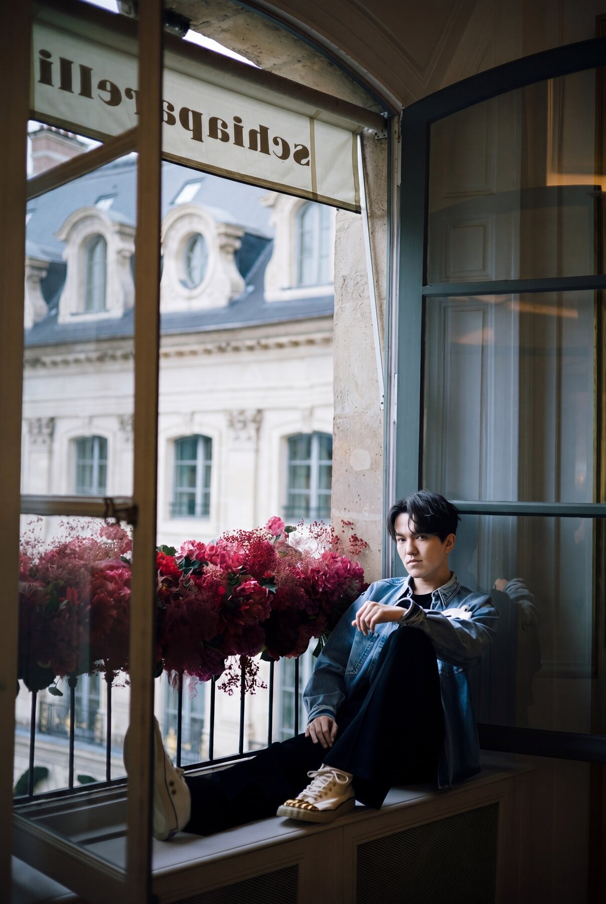 Dimash in denim at the Schiaparelli window seat, Paris